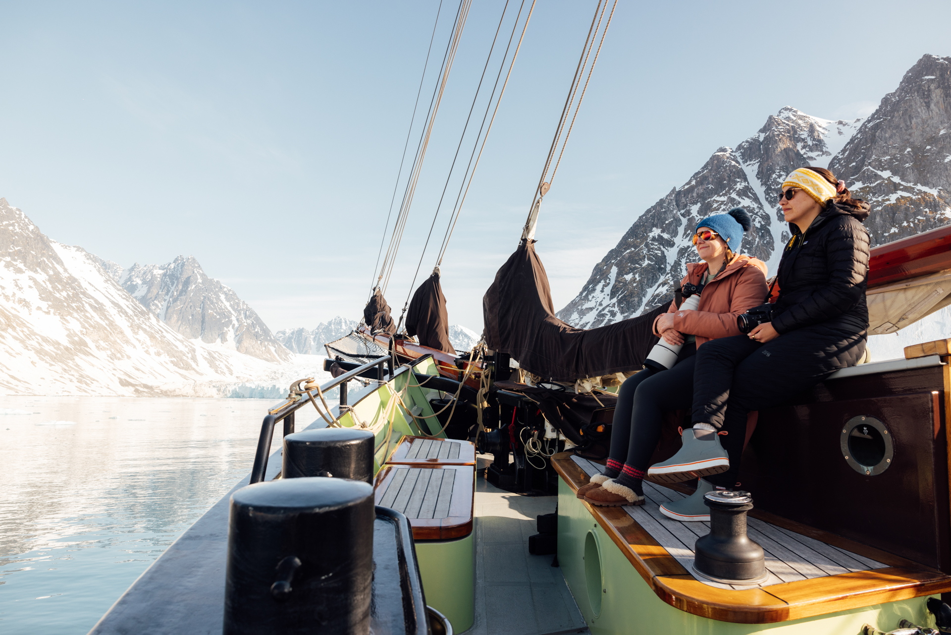 Fotoexpedition im Scoresbysund – Ocean Sherpa mit Radmila Dier © Erica Connolly Zwei Fotografinnen auf dem Deck der Ocean Sherpa im arktischen Fjord